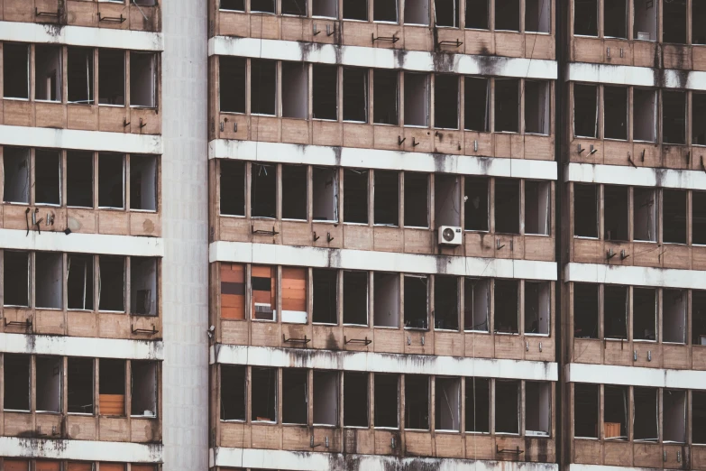 a building is seen from the ground, showing broken windows