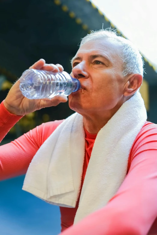 a woman drinking water out of a water bottle