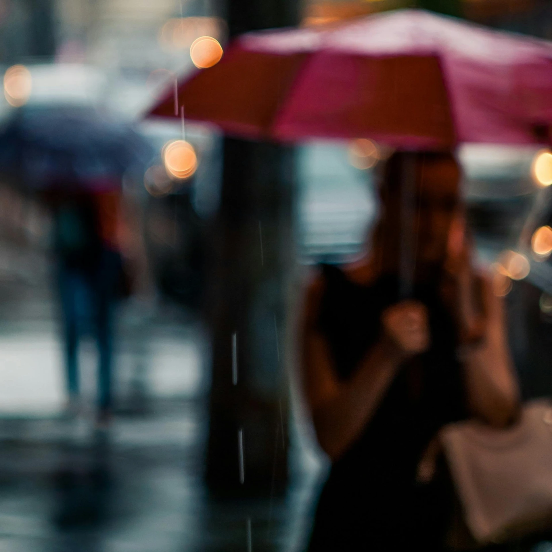 the woman is on the sidewalk using her cell phone