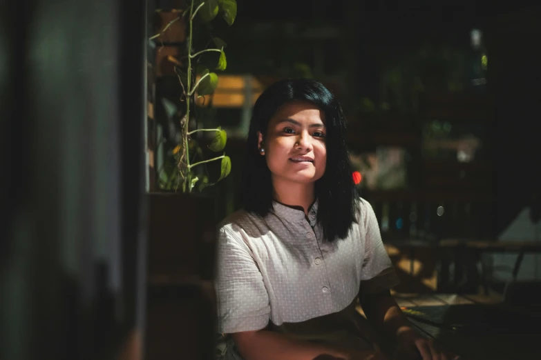 a woman sitting and looking away from the camera