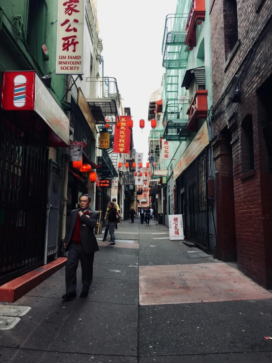 the streets of an alleyway in hong kong are narrow