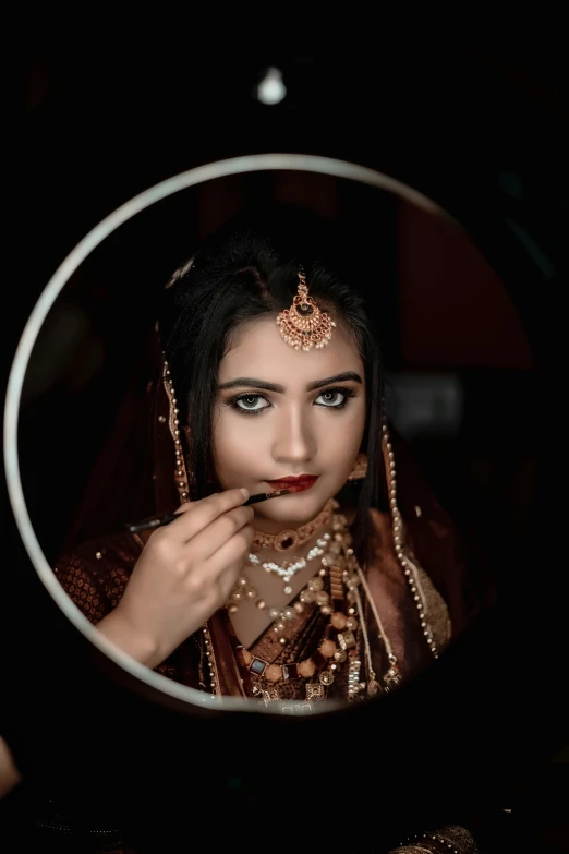 woman in a bridal outfit looking in mirror