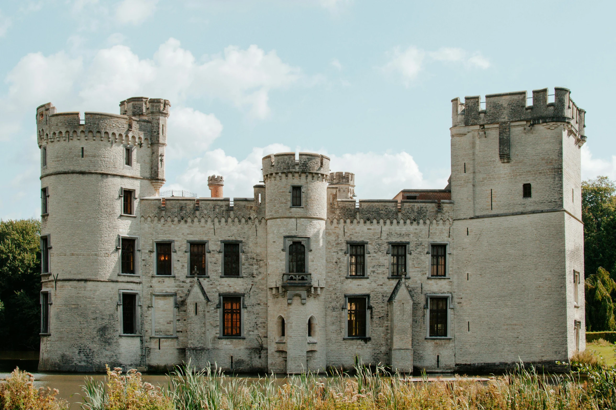 old, brick building with brown windows and a tall tower