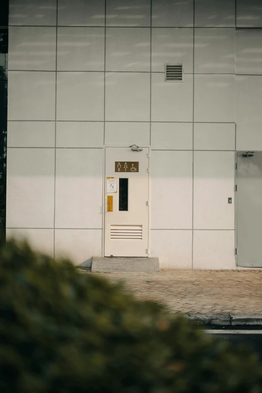 a door with a sign sitting next to it near a building