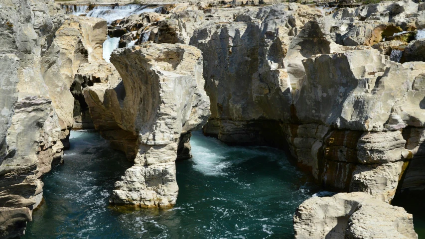 water running under the rocks in the river