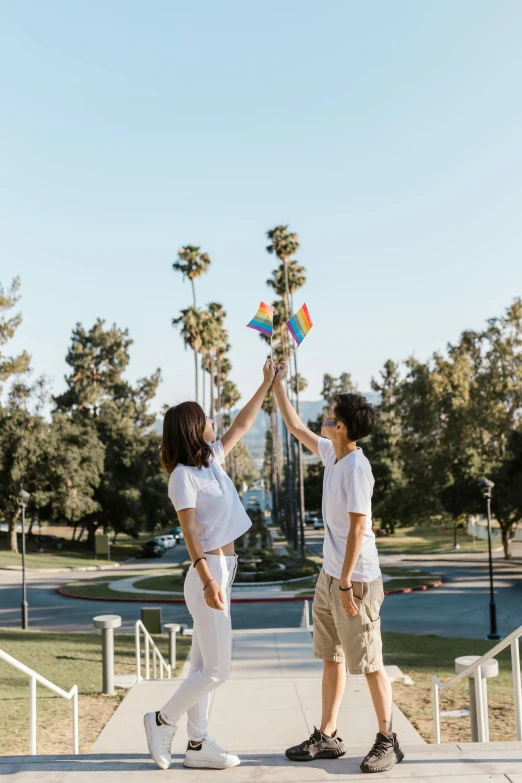 a man and a woman giving each other a high five