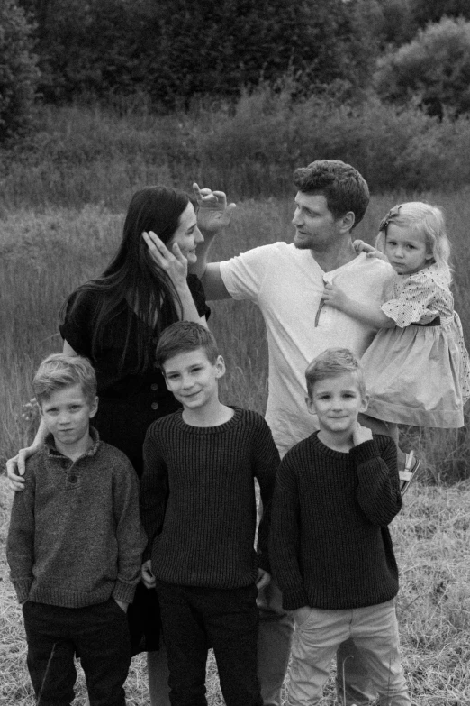 this family has four young children posing for the camera