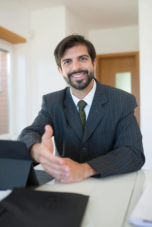 a man in a suit sits in an office