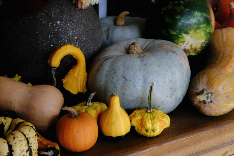 a bunch of squash sit on the mantle