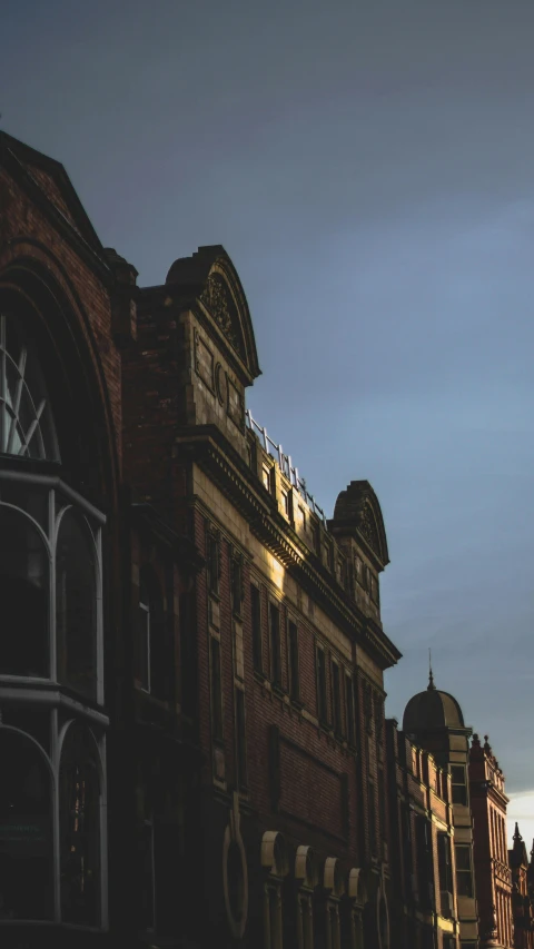 a tall brick building has many windows