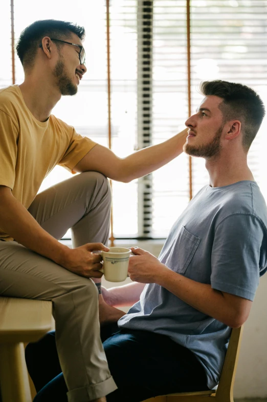 a man having his make up done by a friend