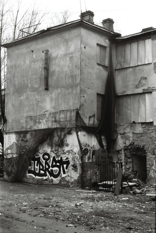 an old abandoned building with a graffiti mural on it