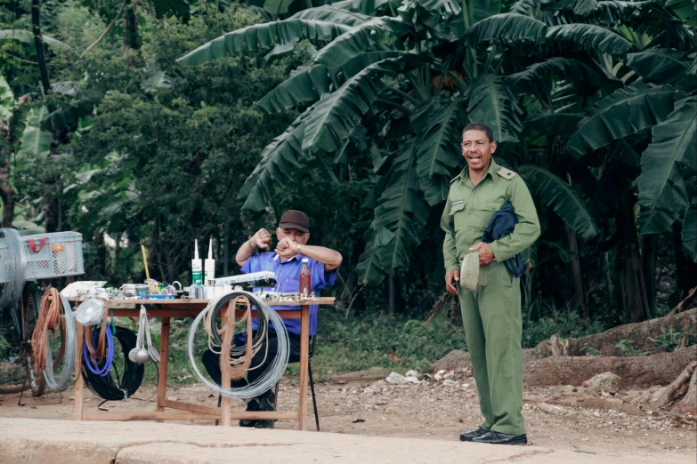 two men who are standing around a table