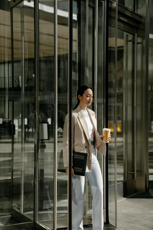 a woman in white pants is standing outside