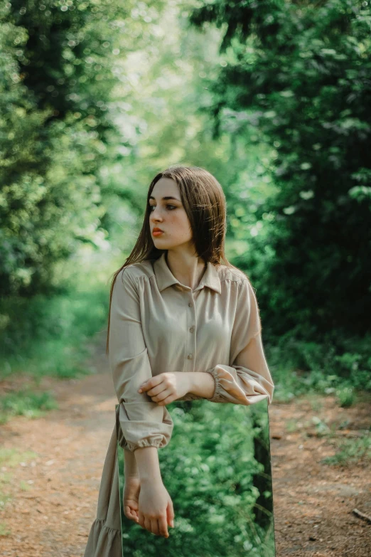 woman with large  walking in forest next to trees