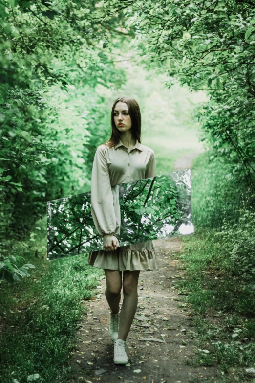 a woman holding an umbrella in a forest