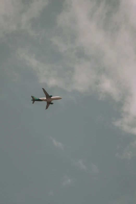 an airplane flies high in the sky with clouds