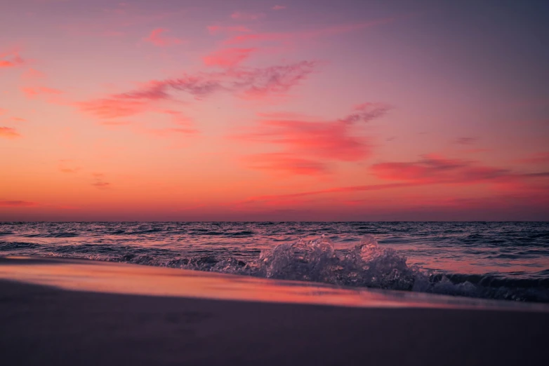 a beach covered in waves next to the ocean