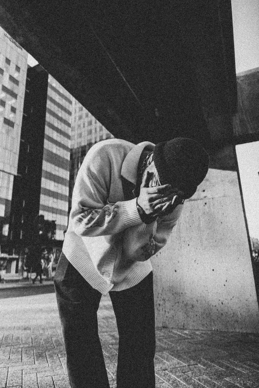 a man standing on the street while talking on a cell phone