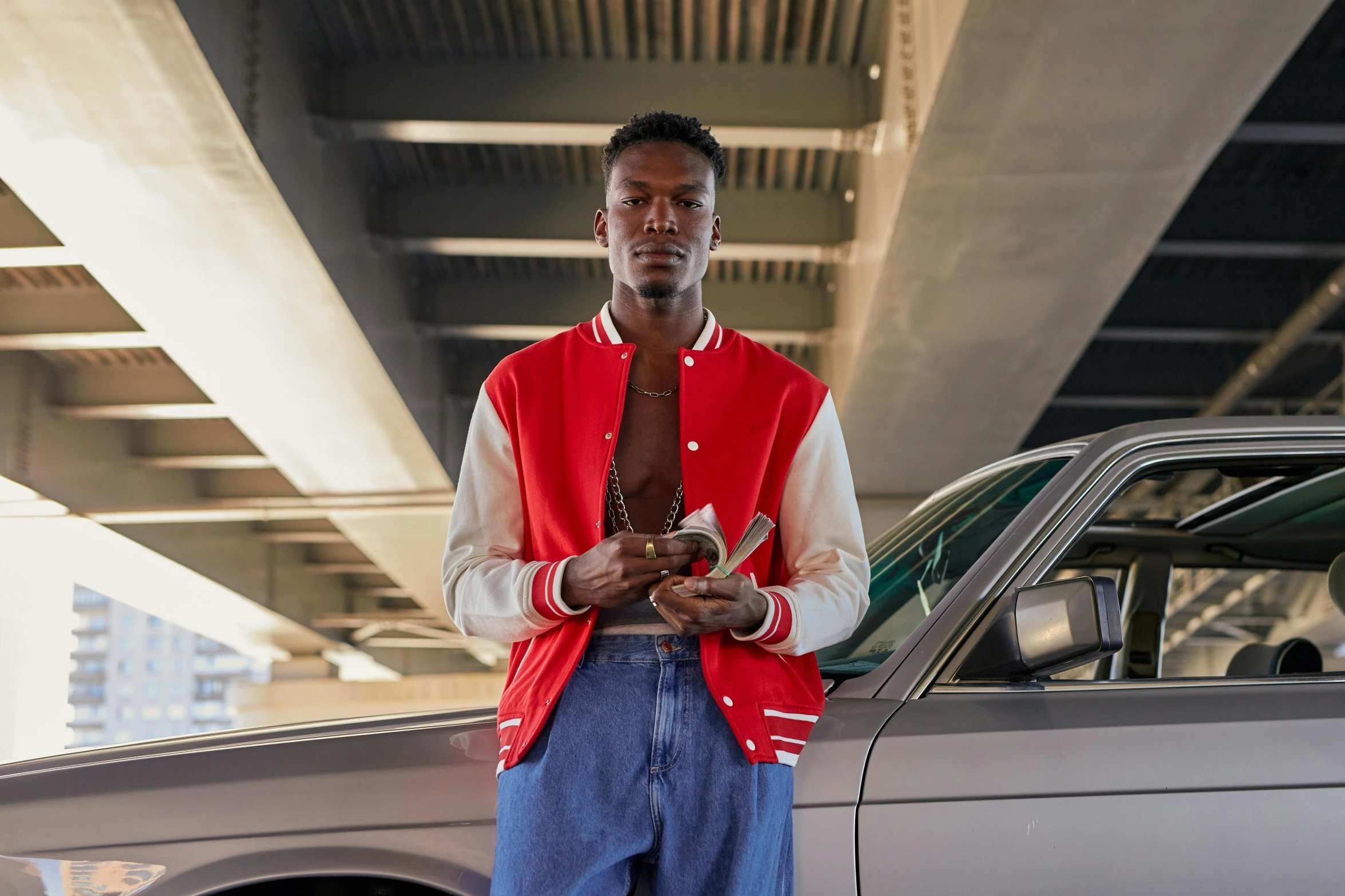 an african man is standing in front of a car