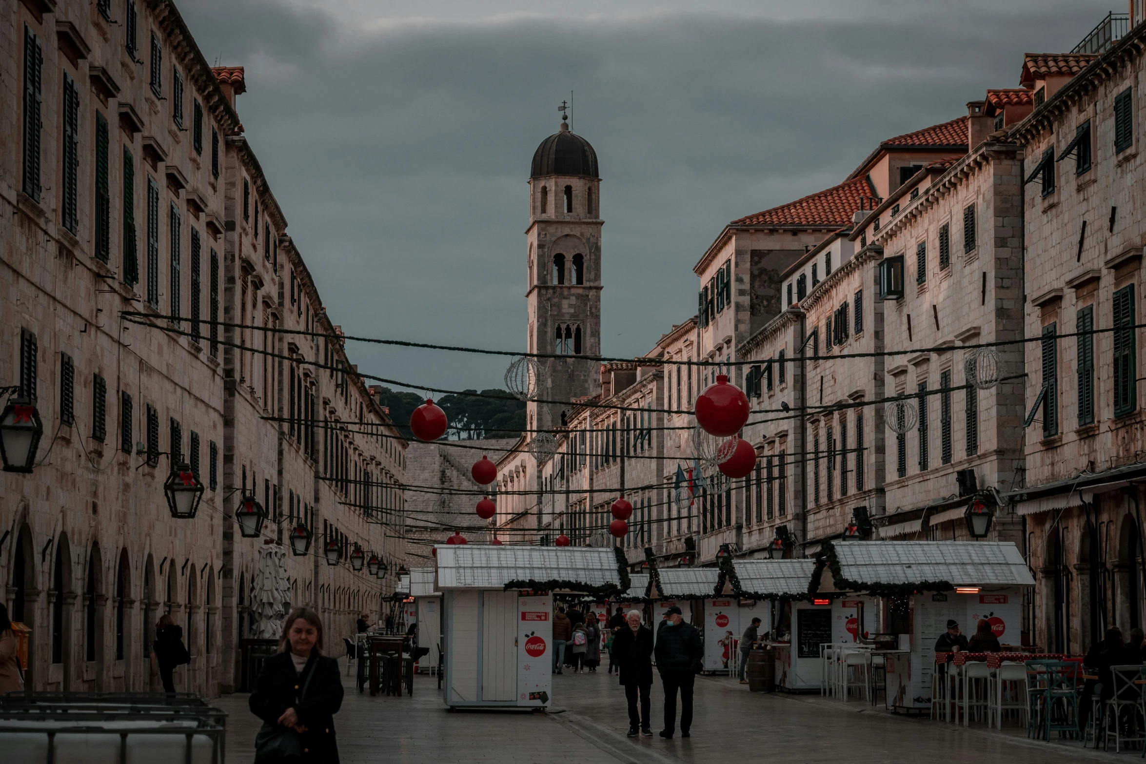 a street scene showing people walking in a city