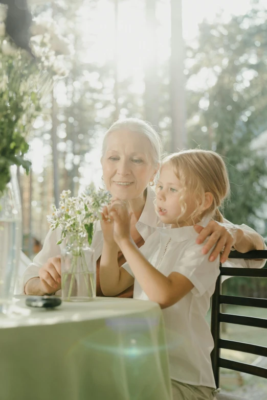 an old woman and young child sitting at a table