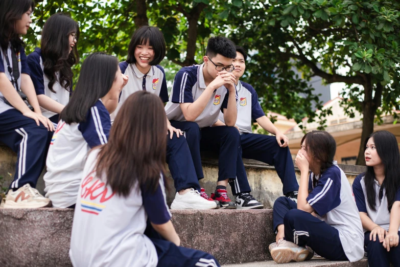 a group of people sitting around a park bench