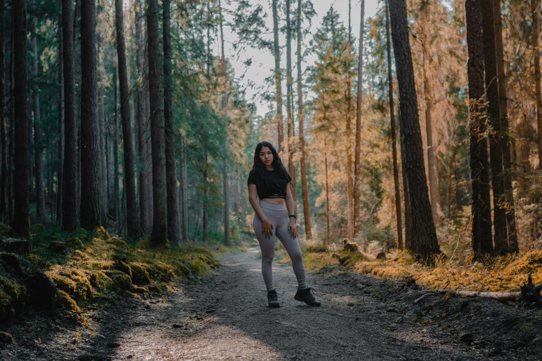 a person standing on a trail in a wooded area