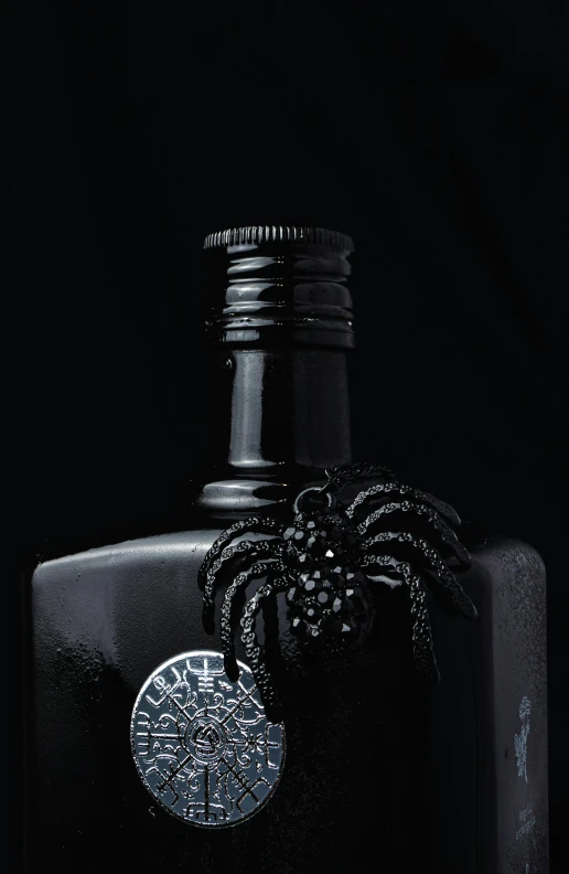 black bottle with a white top in a dark background