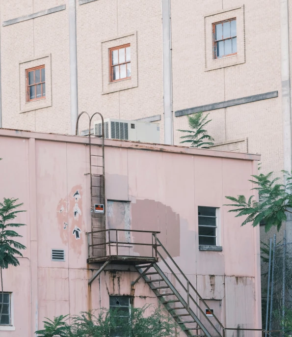 stairs lead up to an older pink building