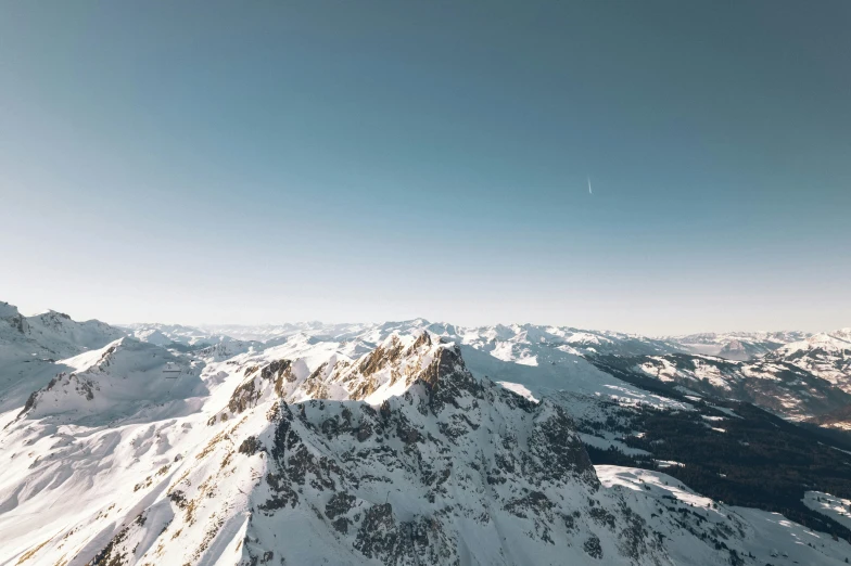 snow covered mountains and mountains are seen from the air