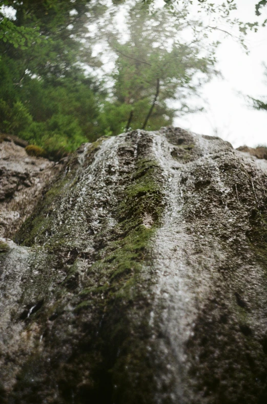 an extreme close up of rocks and a small waterfall