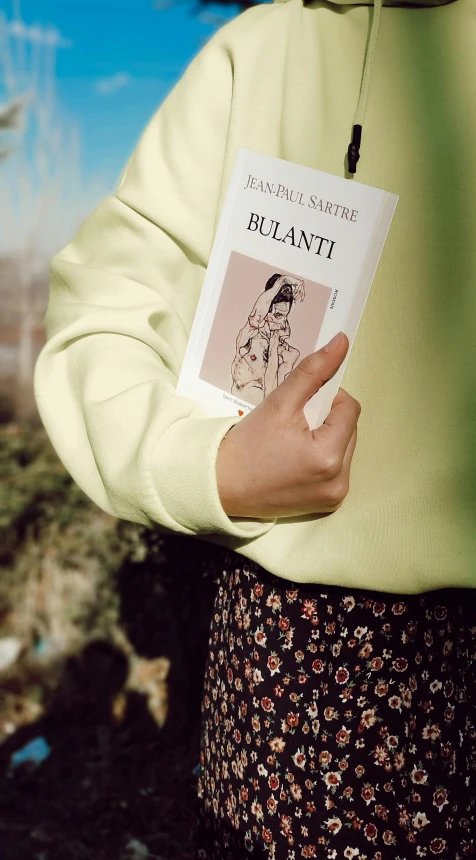 a close up of a person holding a book