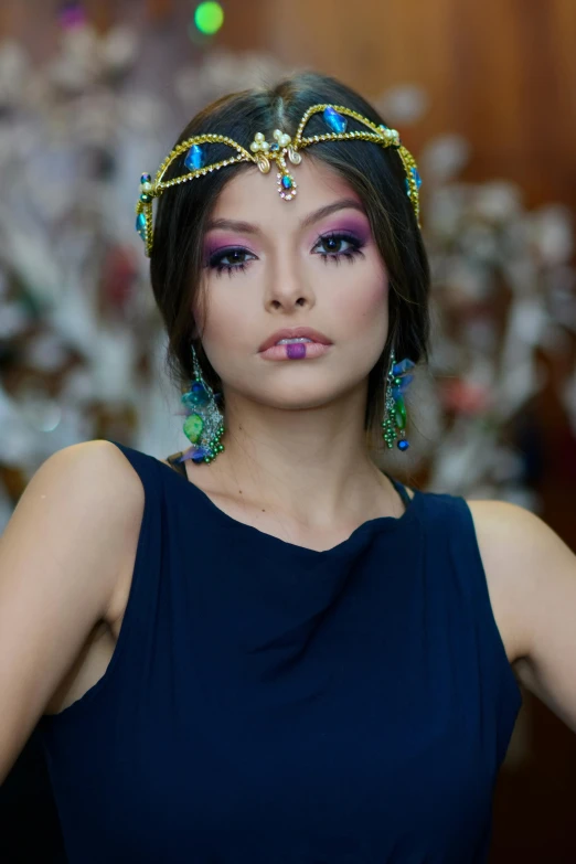 a young woman is posing with an elaborate headband