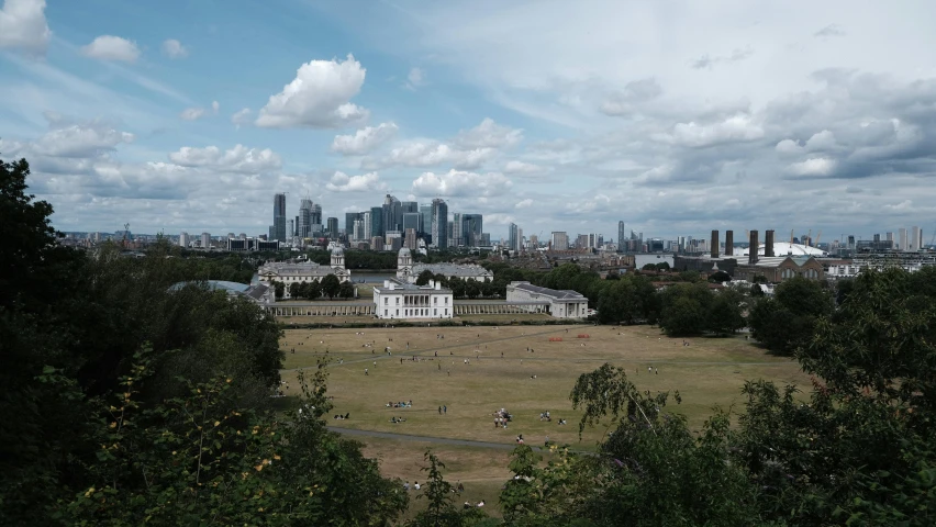 a view of a city with trees, people and some buildings