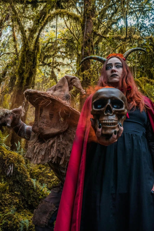 a man in a skeleton mask stands in the woods with other people