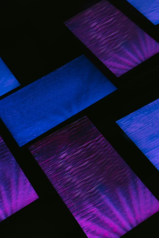 several square tiles are lit up purple, blue and black