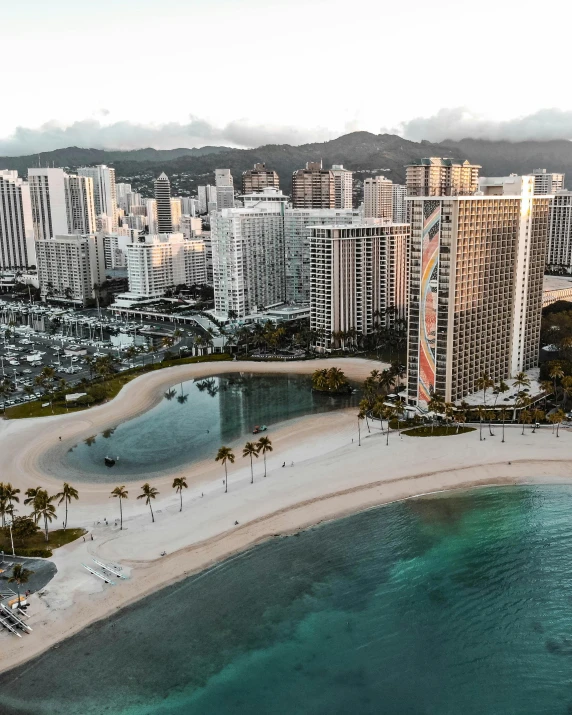 an aerial view of the ocean and buildings in hawaii