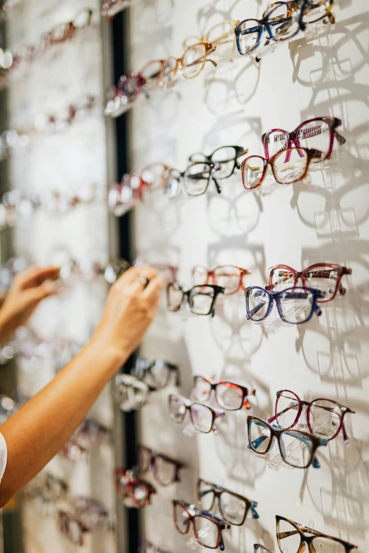 a person that is looking at some glasses