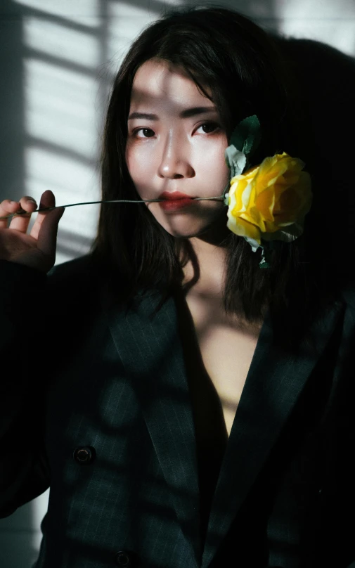 young woman holding flowers in both her face