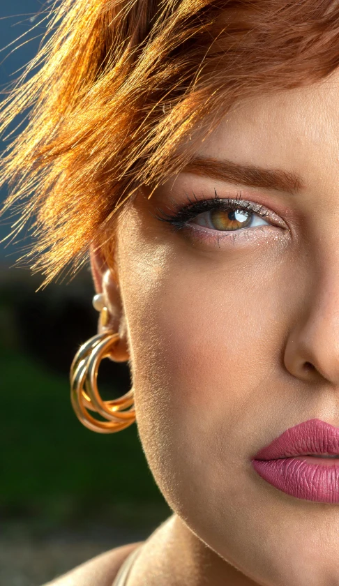 woman with red hair and bright makeup posing for picture