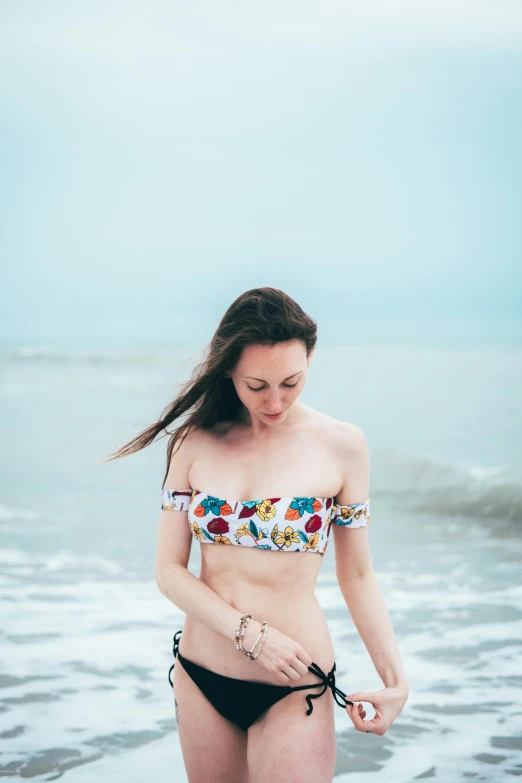 a beautiful woman in a bikini standing in the water