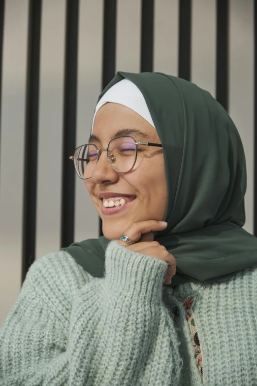 a woman with glasses is smiling at the camera