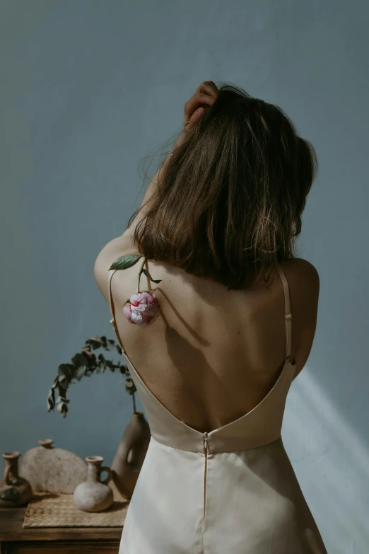 a woman with flower tattooed on her back