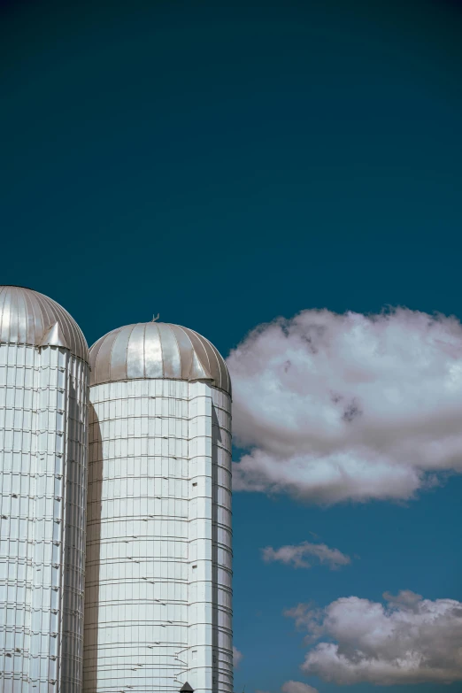 a couple of big buildings sitting under a blue sky