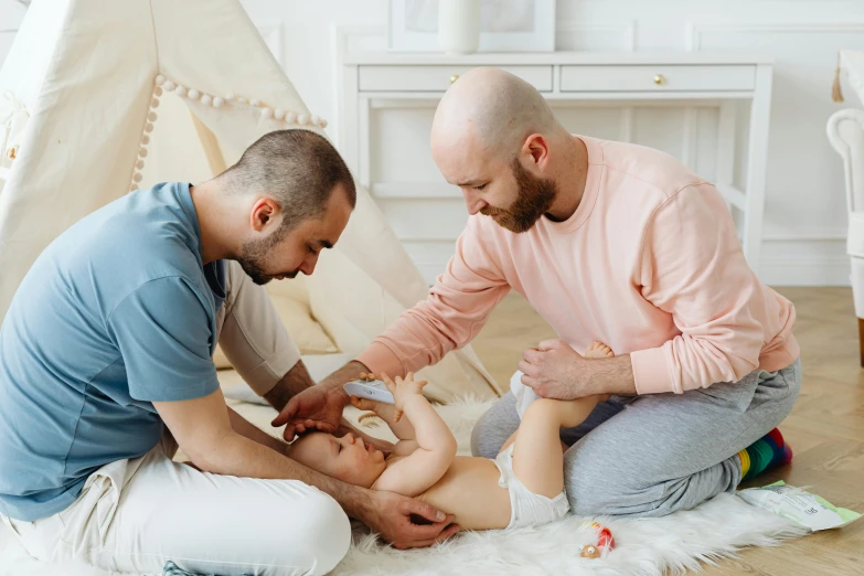 a dad putting a bottle on his baby