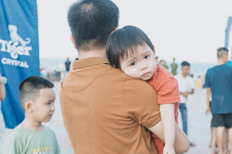 a little boy being carried on his father's shoulders