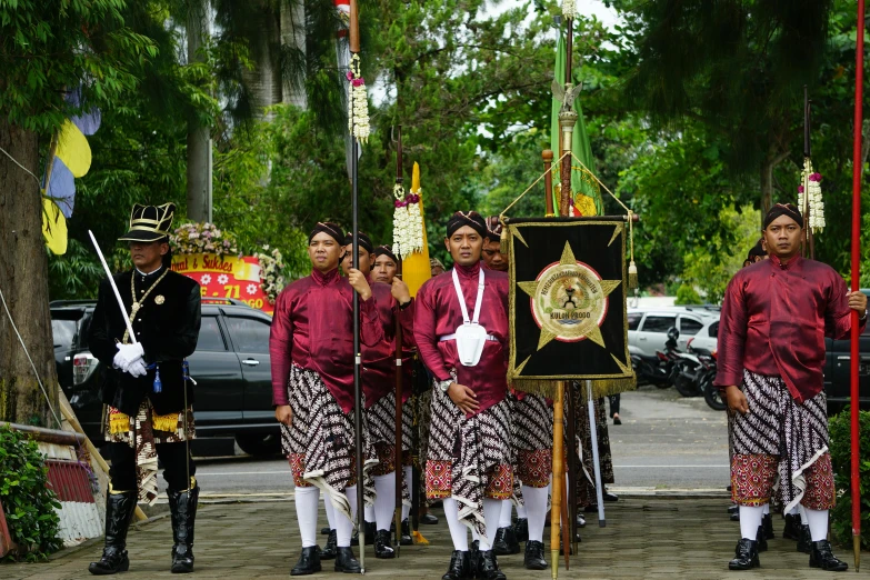 a group of people are standing in front of a wooden plaque