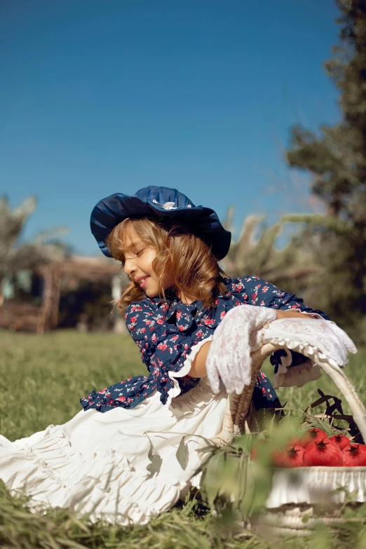 an adorable little girl in a dress and a hat