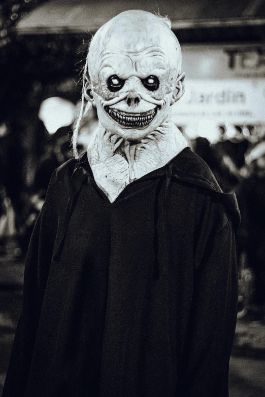 a creepy white head wearing black shirt and black hat